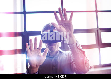 Businessman using virtual reality device Stock Photo