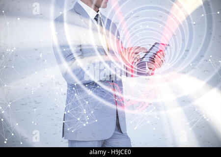 Composite image of businessman using tablet pc Stock Photo