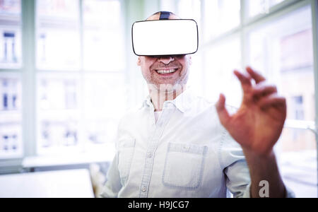 Smiling graphic designer using virtual reality headset Stock Photo