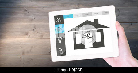 Composite image of feminine hand holding tablet Stock Photo