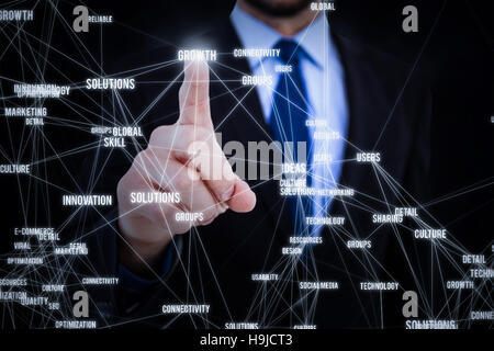Composite image of businessman pointing his finger at camera Stock Photo
