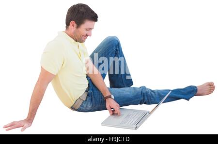 Smiling man using a laptop Stock Photo