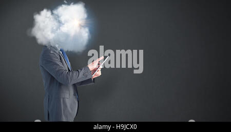 Composite image of businessman using his tablet pc Stock Photo