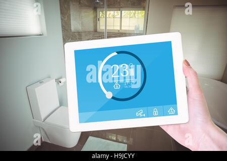 Composite image of feminine hand holding tablet Stock Photo