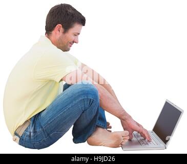 Smiling man using a laptop Stock Photo