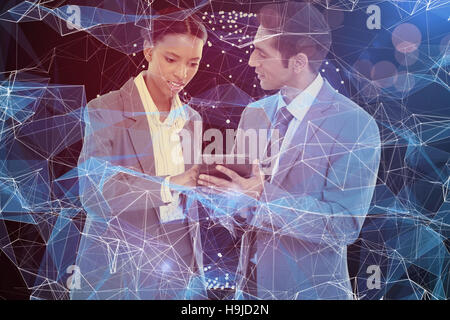 Composite image of business people discussing over digital tablet Stock Photo