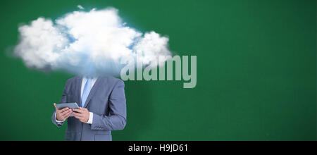 Composite image of businessman using tablet Stock Photo