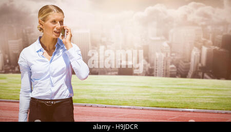 Composite image of smiling businesswoman on the phone Stock Photo