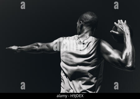 Composite image of rear view of sportsman practising discus throw Stock Photo