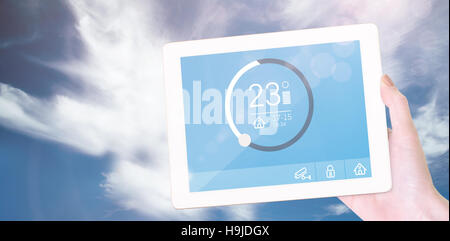 Composite image of feminine hand holding tablet Stock Photo