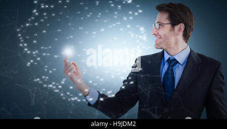 Composite image of smiling businessman pointing at a copy space Stock Photo