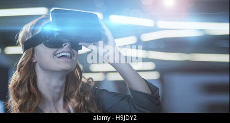 Smiling businesswoman using virtual reality simulator Stock Photo