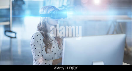 Businesswoman using virtual reality headset in office Stock Photo