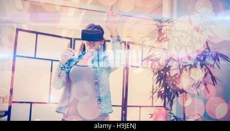 Businesswoman gesturing while using virtual reality headset Stock Photo