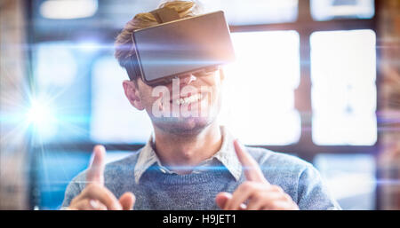 Businessman gesturing while using virtual reality headset Stock Photo