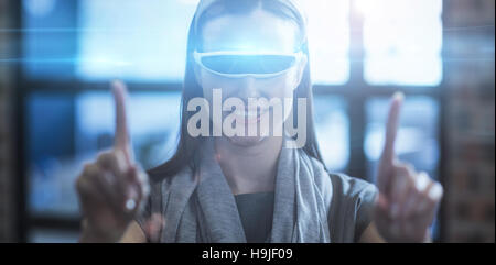 Businesswoman gesturing while using virtual reality headset Stock Photo
