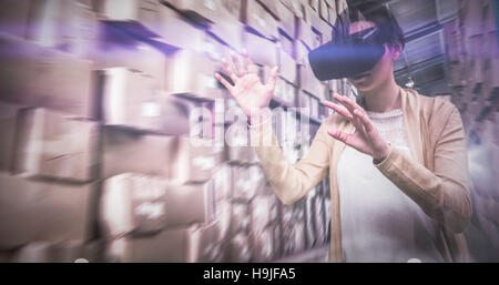 Composite image of businesswoman holding virtual glasses Stock Photo