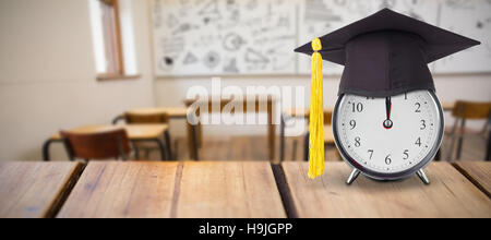 Composite image of mortar board on alarm Stock Photo