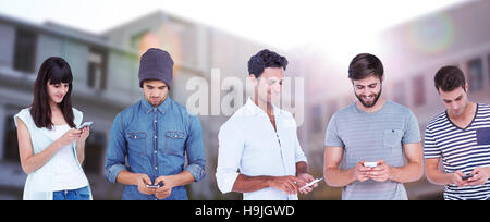 Composite image of handsome man text messaging through smart phone Stock Photo