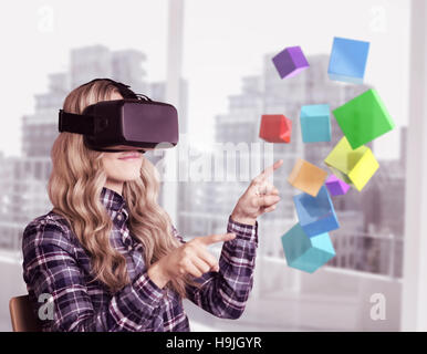 Composite image of pretty casual worker using oculus rift Stock Photo