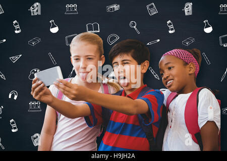 Composite image of school kids taking selfie in school corridor Stock Photo