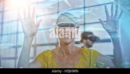 Composite image of fish swimming with shark in darkest water Stock Photo