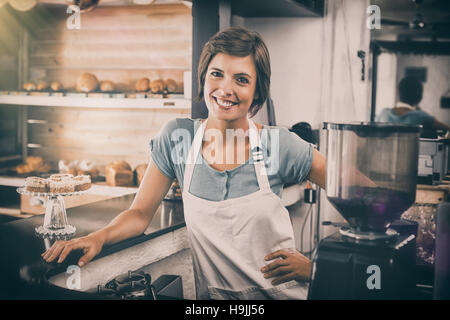 Pretty barista smiling at camera Stock Photo