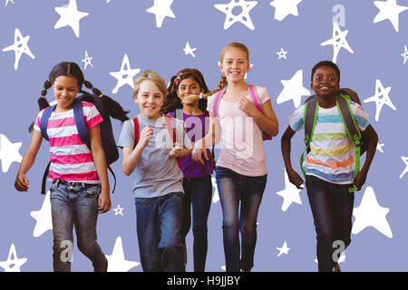 Composite image of school kids running in school corridor Stock Photo
