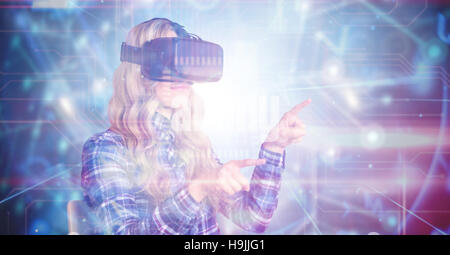 Composite image of pretty casual worker using oculus rift Stock Photo