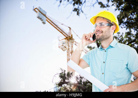 Composite image of male architect with blueprint talking on mobile phone Stock Photo