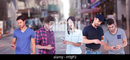 Composite image of handsome man text messaging through smart phone Stock Photo