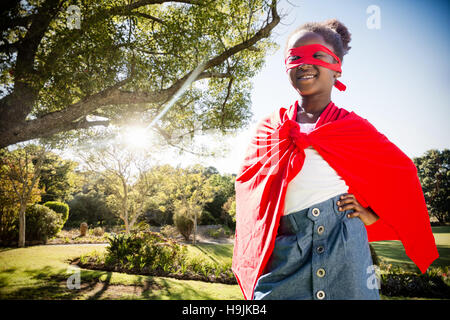 Composite image of happy girl in red cape Stock Photo