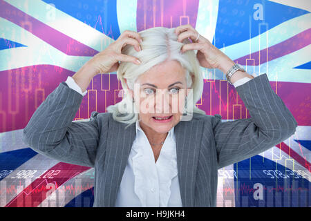 Composite image of stressed businesswoman with hands on head Stock Photo
