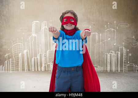 Composite image of boy in superhero costume Stock Photo