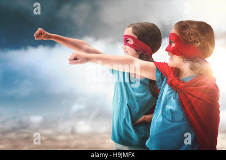 Composite image of sister and brother in red cape Stock Photo