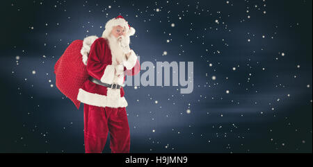 Composite image of santa asking for quiet with bag Stock Photo