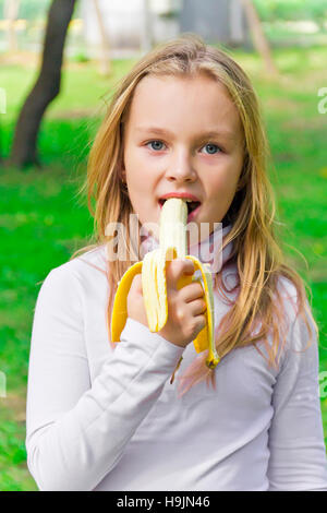 Photo of girl are eating banana in summer Stock Photo