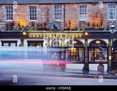 UK, Scotland, Lothian, Edinburgh, Twilight view of the Greyfriars Bobby's Bar and the sculpture of Bobby. Stock Photo