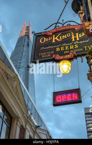 Old King's head Traditional English pub sign with the Shard skyscraper in the background, Borough High Street,London,England Stock Photo