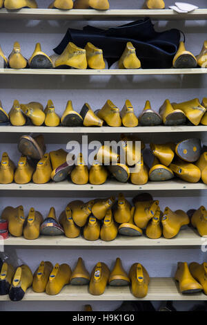 Shoe lasts on shelf in shoemaker workshop Stock Photo