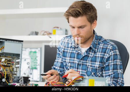 repairman fixing electronic devices Stock Photo