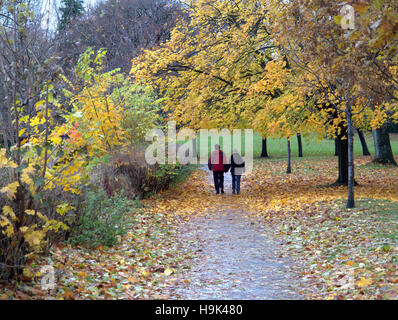 Glasgow park scene couple holding hands and walking on path or road Stock Photo