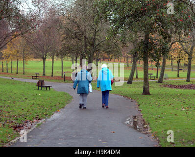 Glasgow park scene two old ladies walking on the path or road Stock Photo