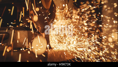 Welder welding a metal in workshop Stock Photo