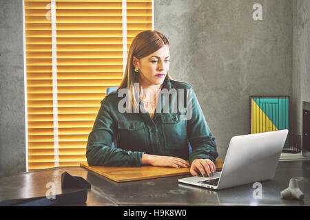 Architect woman working on laptop for new architectural project. Stock Photo