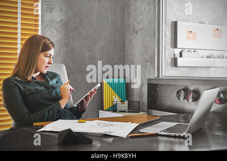 Architect woman working on tablet for new architectural project. Stock Photo