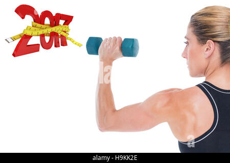 3D Composite image of female bodybuilder holding a blue dumbbell Stock Photo