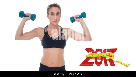 3D Composite image of female bodybuilder holding two dumbbells with arms up Stock Photo