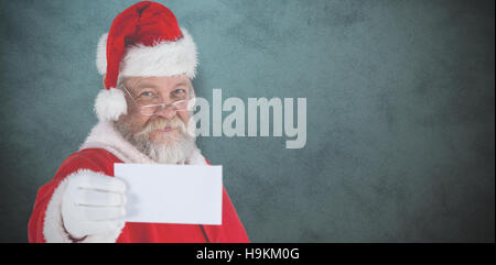 Composite image of close-up of santa claus holding blank paper Stock Photo