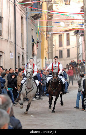 Couple ride reckless horserace 'Sa Carrela e Nanti', during the carnival at Santu Lussurgiu, Oristano, Sardinia, Italy, Europe Stock Photo